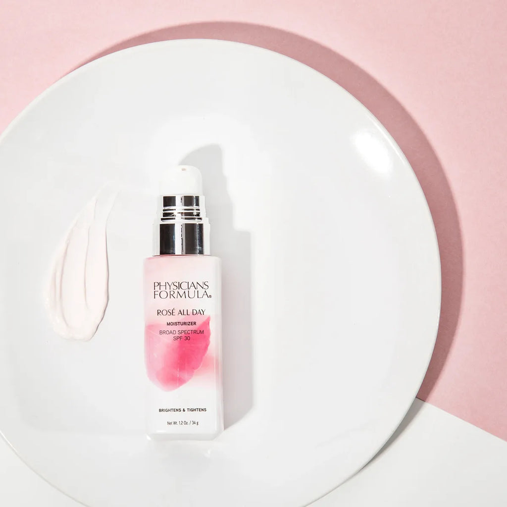 Physicians Formula Rosé All Day Moisturizer SPF 30 on white plate with product swatch on pink background