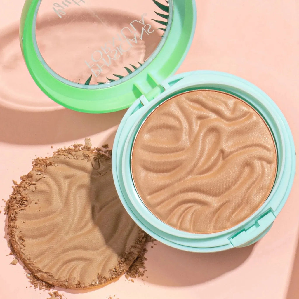 Physicians Formula Murumuru Butter Bronzer compact with swirled texture and crushed powder on peach background