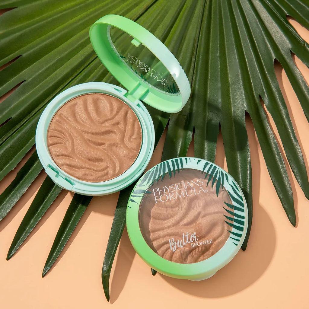 Physicians Formula Butter Bronzer compact open and closed on a tropical leaf background
