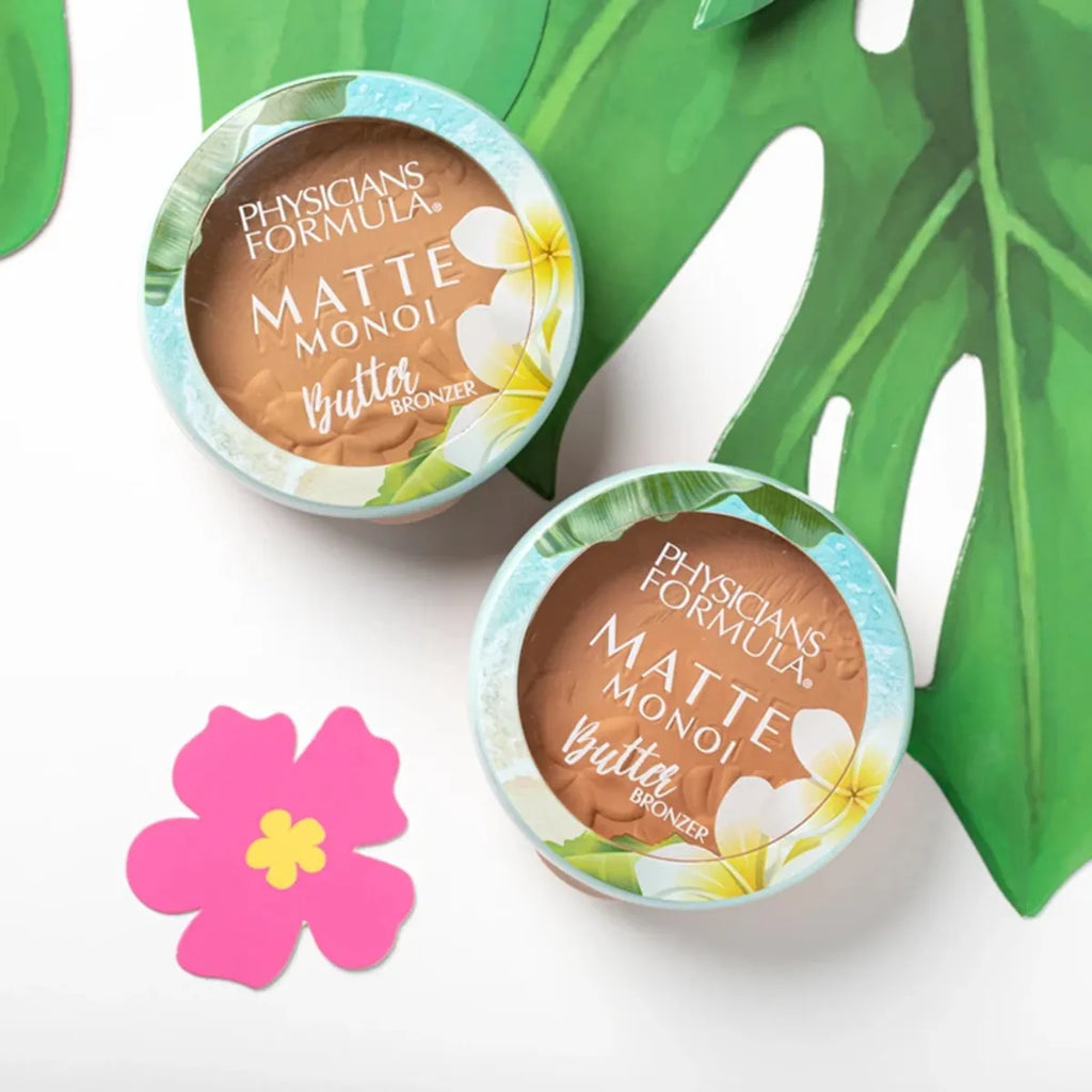 Two Physicians Formula Matte Monoi Butter Bronzer compacts on a white surface with tropical leaf and flower illustrations