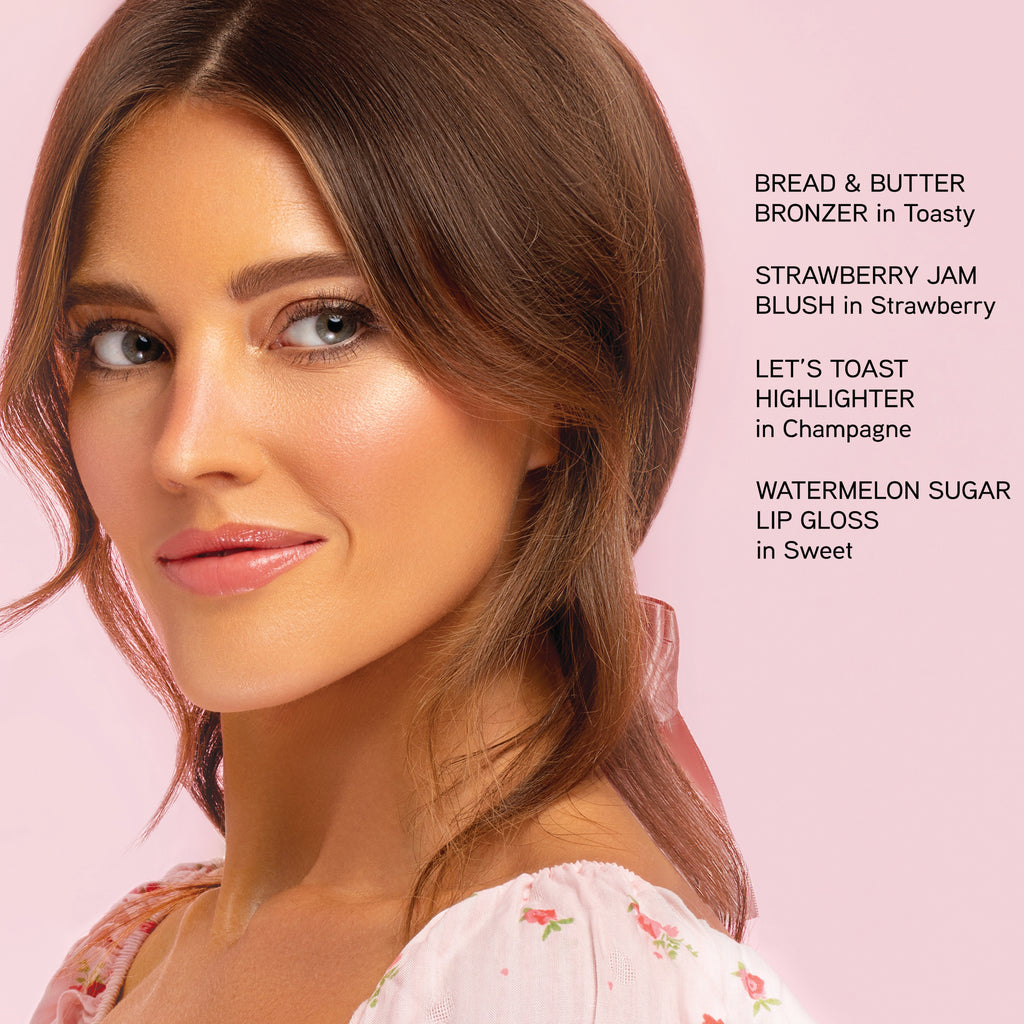 Model wearing Bread & Butter Collection. Bread & Butter in Toasty. Strawberry Jam Blush in Strawberry. Let's Toast Highlighter in Champagne. Watermelon Sugar Lip Gloss in Sweet