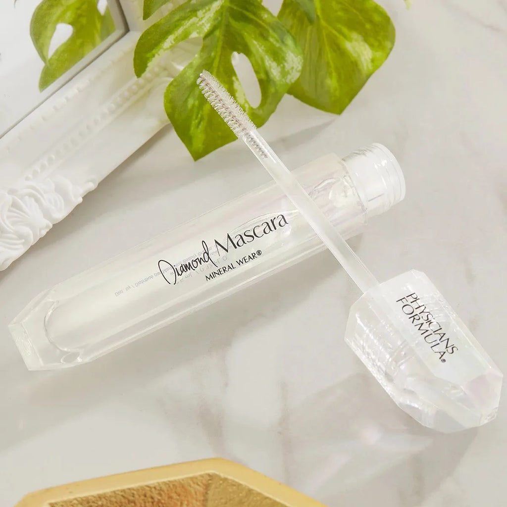 Physicians Formula Diamond Mascara in clear formula with crystal-inspired packaging on a marble surface