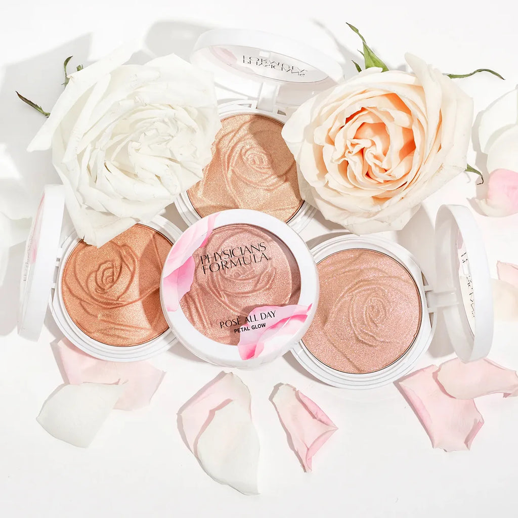 Physicians Formula Rosé All Day Petal Glow highlighters with embossed rose pattern, surrounded by rose petals and blooms