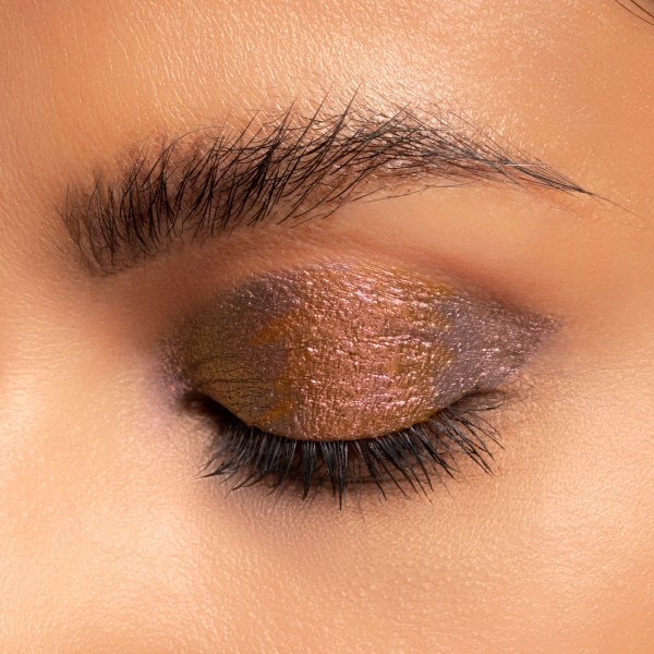 Mineral Wear Diamond Melt-allic Model, closeup of eyeshadow on eyelid in shade Bronze Brilliance