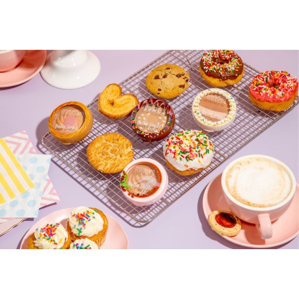 Butter Cheat Day Collection on purple background with variety of desserts, donuts, cookies, coffee