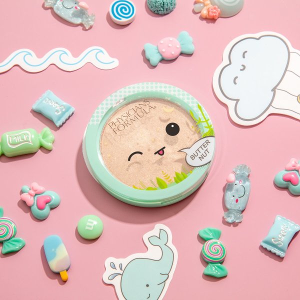 Butter Nut Highlighter on pale pink background with candy and sticker details surrounding the product