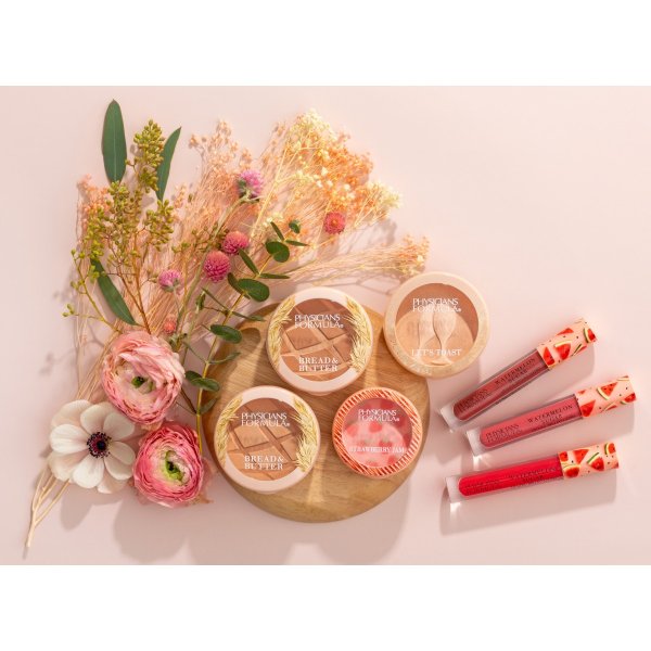 Bread & Butter Collection products laid on pale pink background with flowers