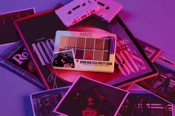 The Breakfast Club Being Bad Feels Pretty Good Eyeshadow Palette on top of miscellaneous 80s-themed items, cassette tapes, photos from TBC film