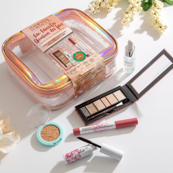 Fan Favorites 5-Piece Makeup Bag - Shimmer Strips Custom Eye Enhancing Extreme Shimmer Shadow and Liner, Skin Booster Vitamin Shot, mini Murumuru Butter Bronzer, Rose Kiss All Day Velvet Color, and mini Rose All Day Mascara laid out on white background with floral details