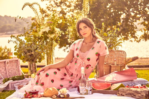 Model wearing Bread & Butter Collection. picnic setting.